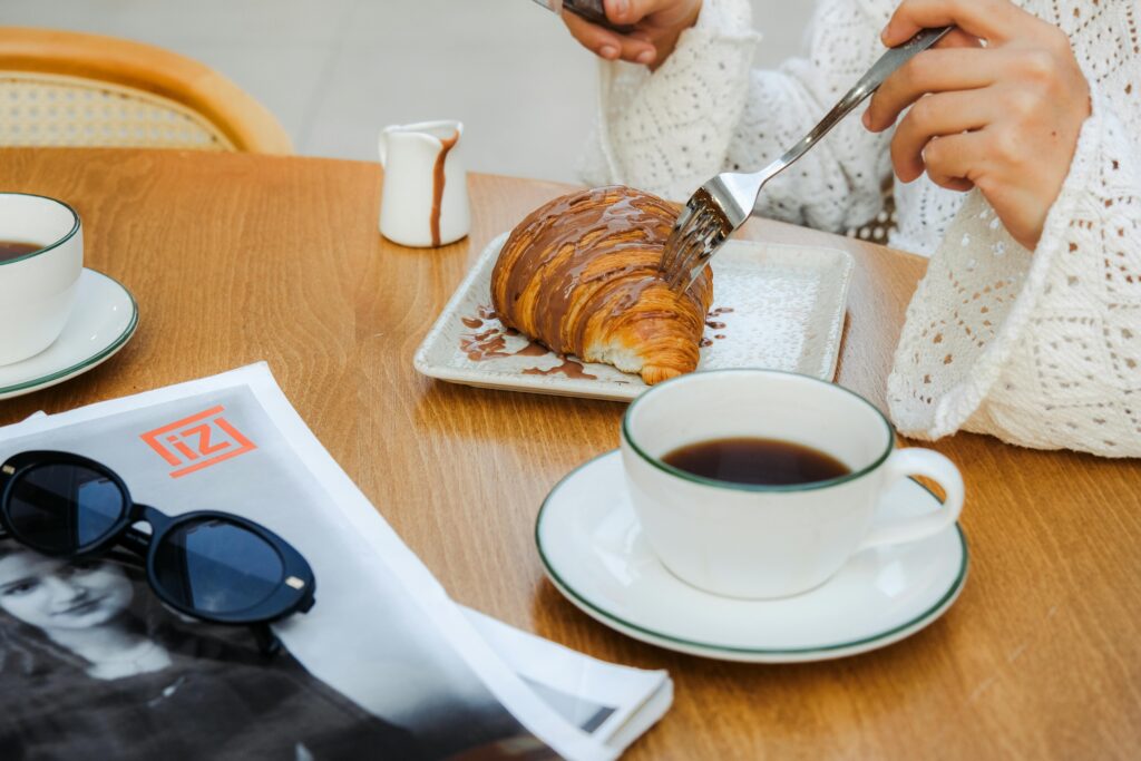 Enjoy a delectable breakfast featuring a chocolate croissant and coffee. Perfect morning indulgence.